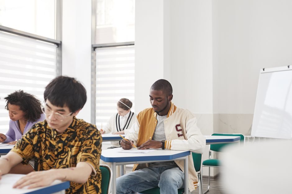 Senior high school students sitting a written trial examination in a school hall