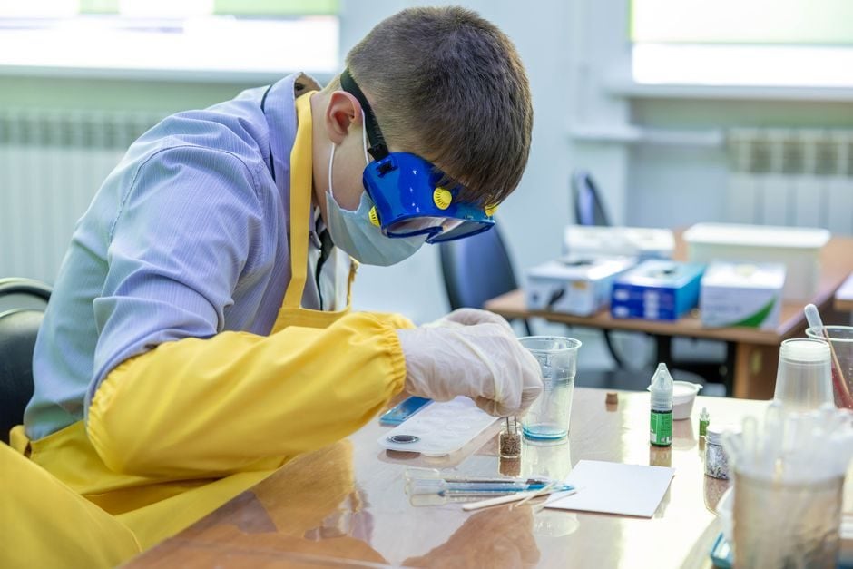 Senior students carrying out a practical investigation in a school science laboratory