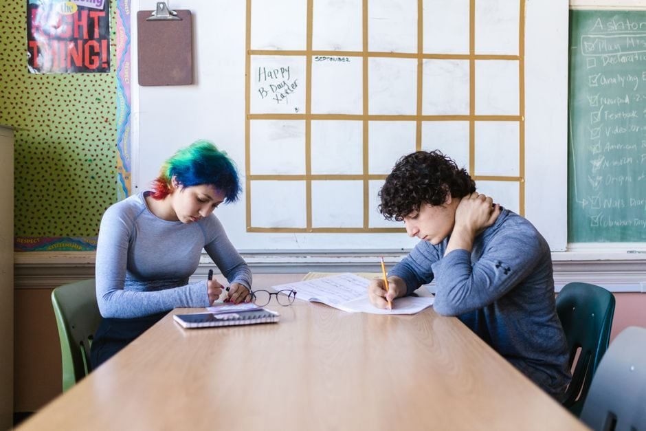 Senior high school students working at desks in a classroom